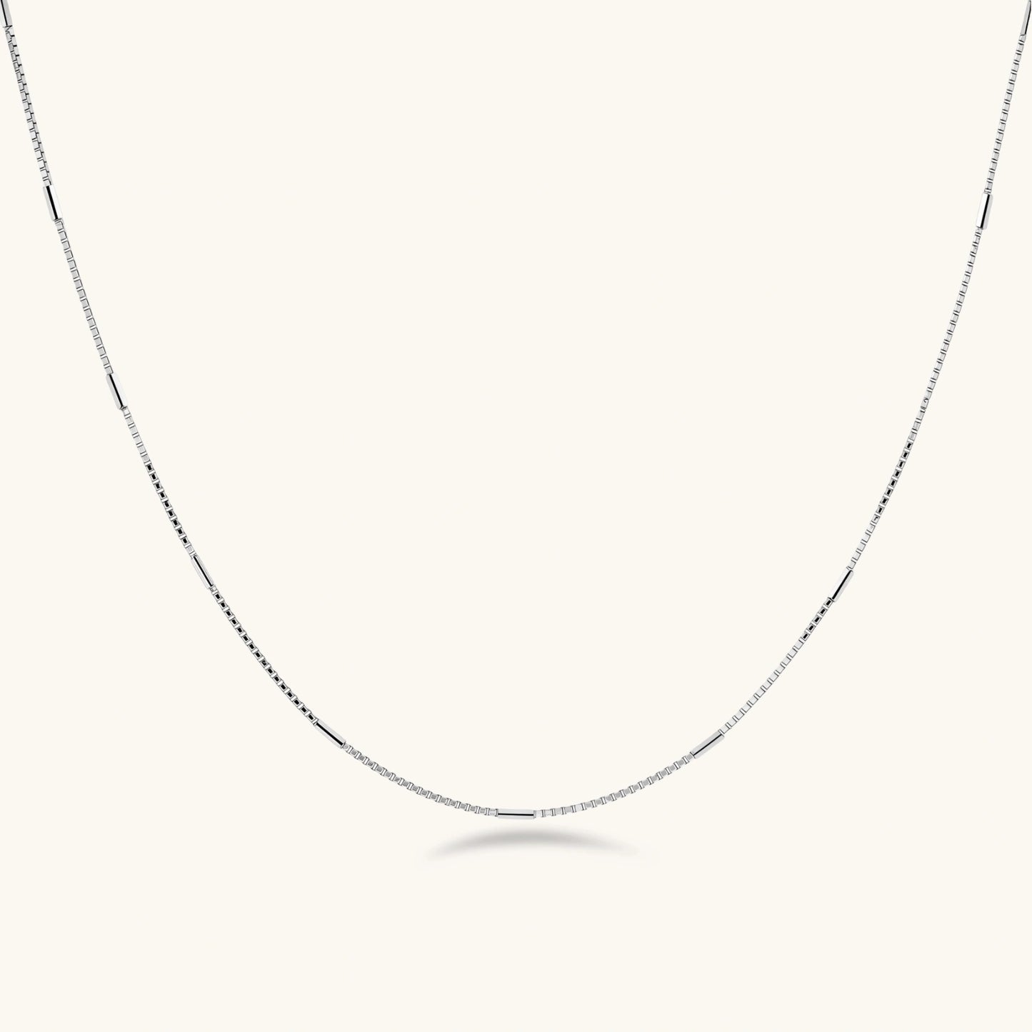 Delicate platinum-plated sterling silver necklace with alternating textured cubic links and smooth chain sections.