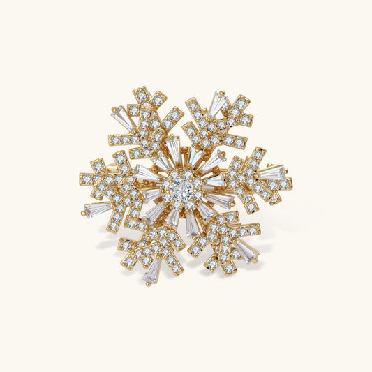 Geometric snowflake brooch with 14K gold-plated copper setting and clear zirconia crystals arranged in radiating pattern.
