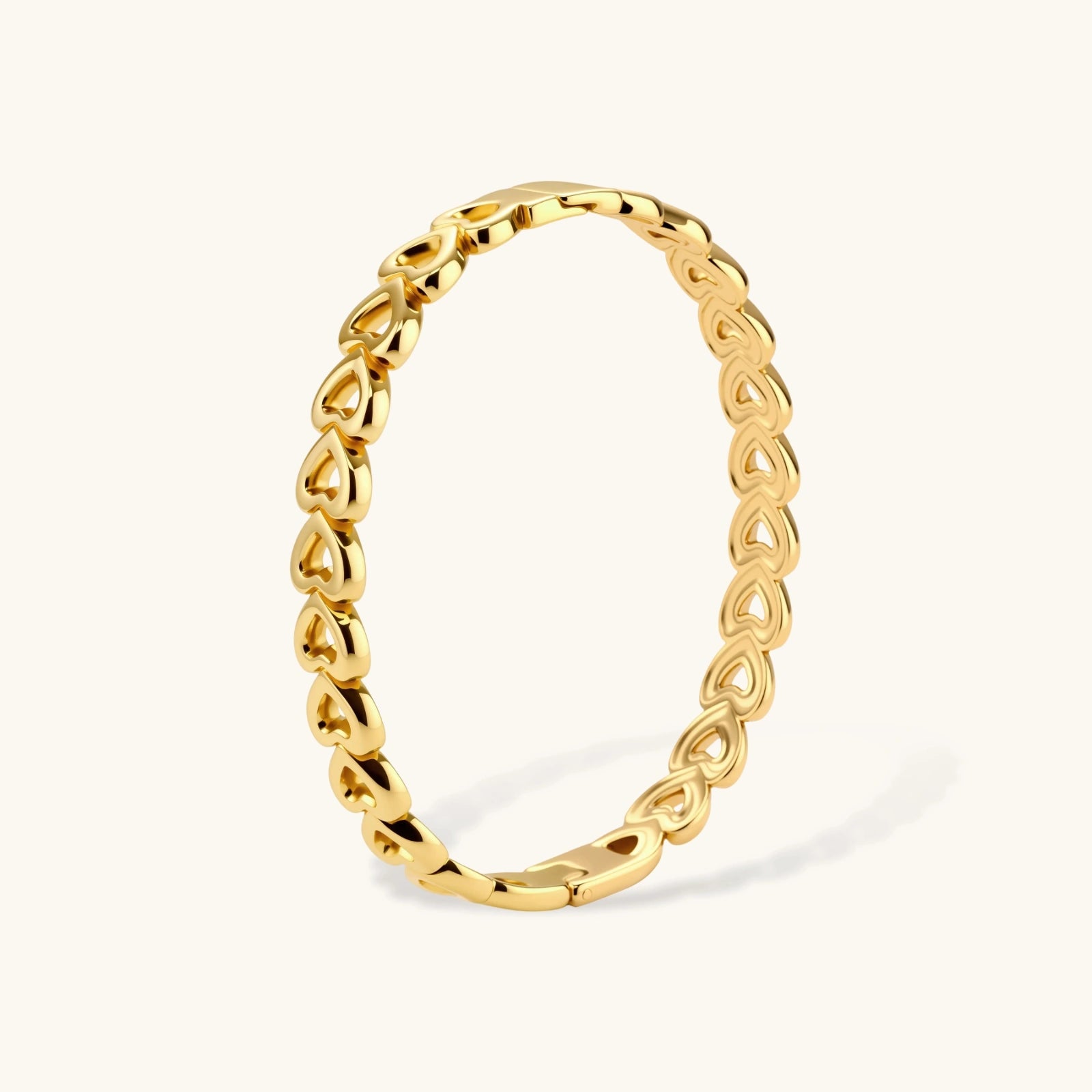 Gold 18K plated stainless steel bangle with continuous open heart links, high-polish finish, on white background.