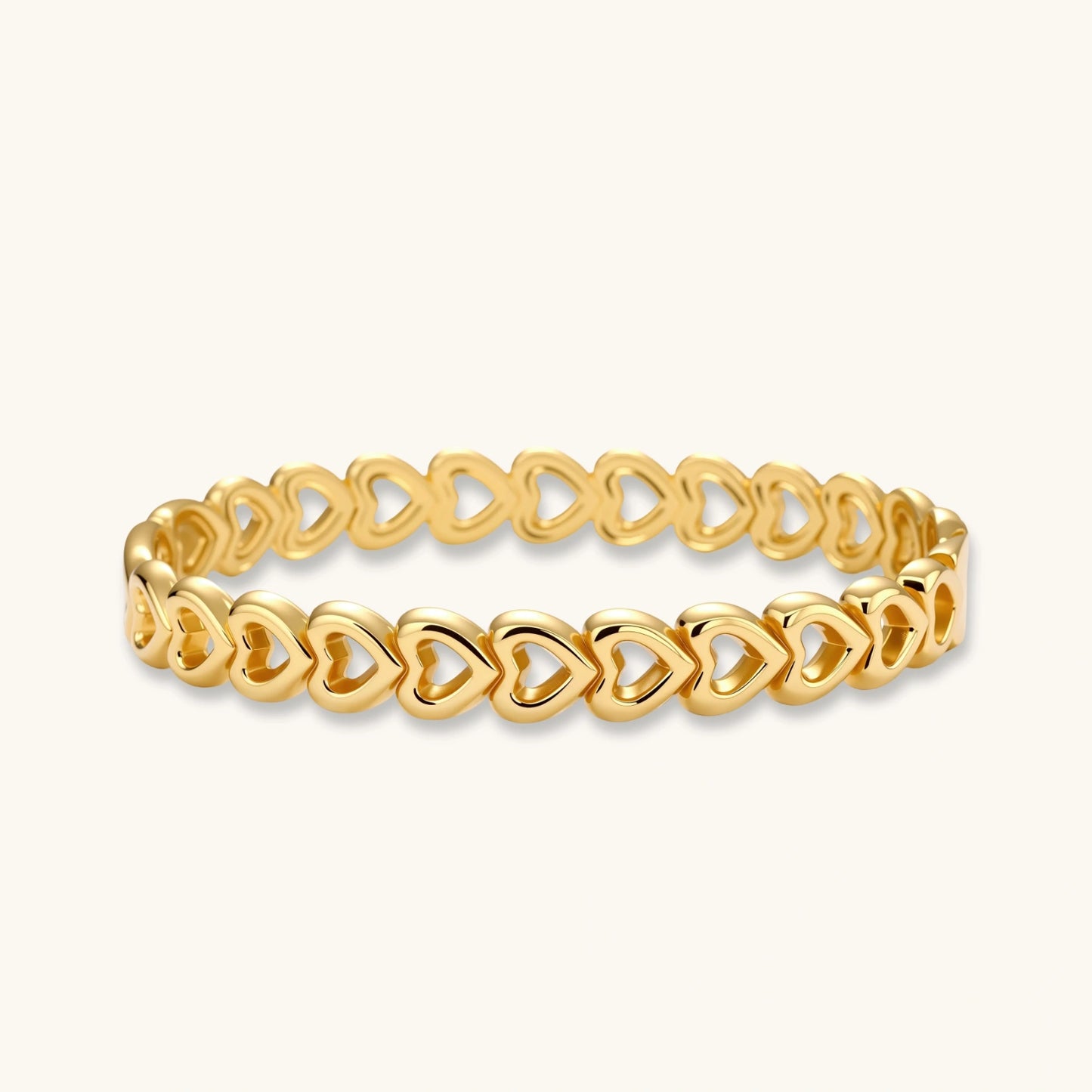 Gold 18K plated stainless steel bangle with continuous open heart links, high-polish finish, on white background.