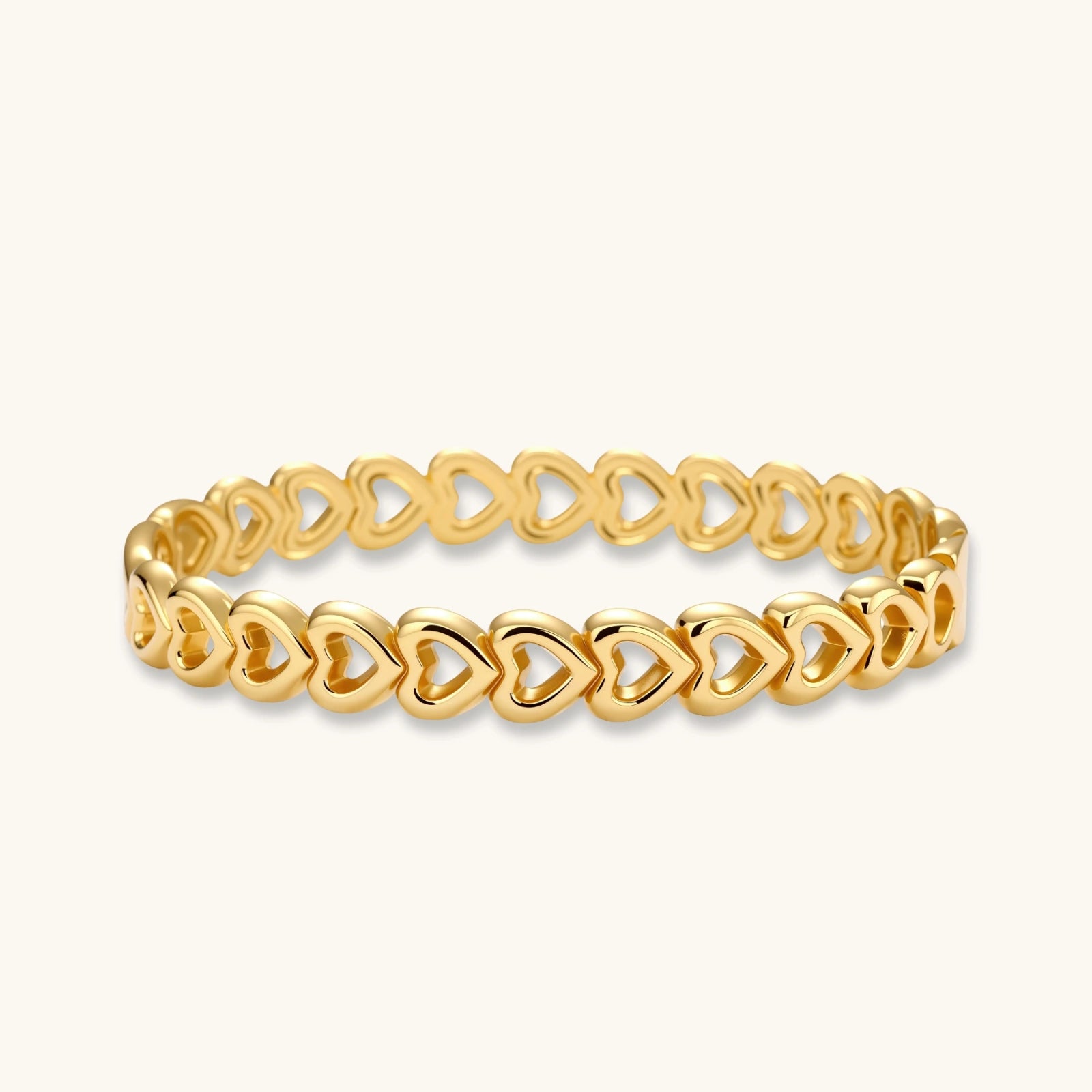 Gold 18K plated stainless steel bangle with continuous open heart links, high-polish finish, on white background.